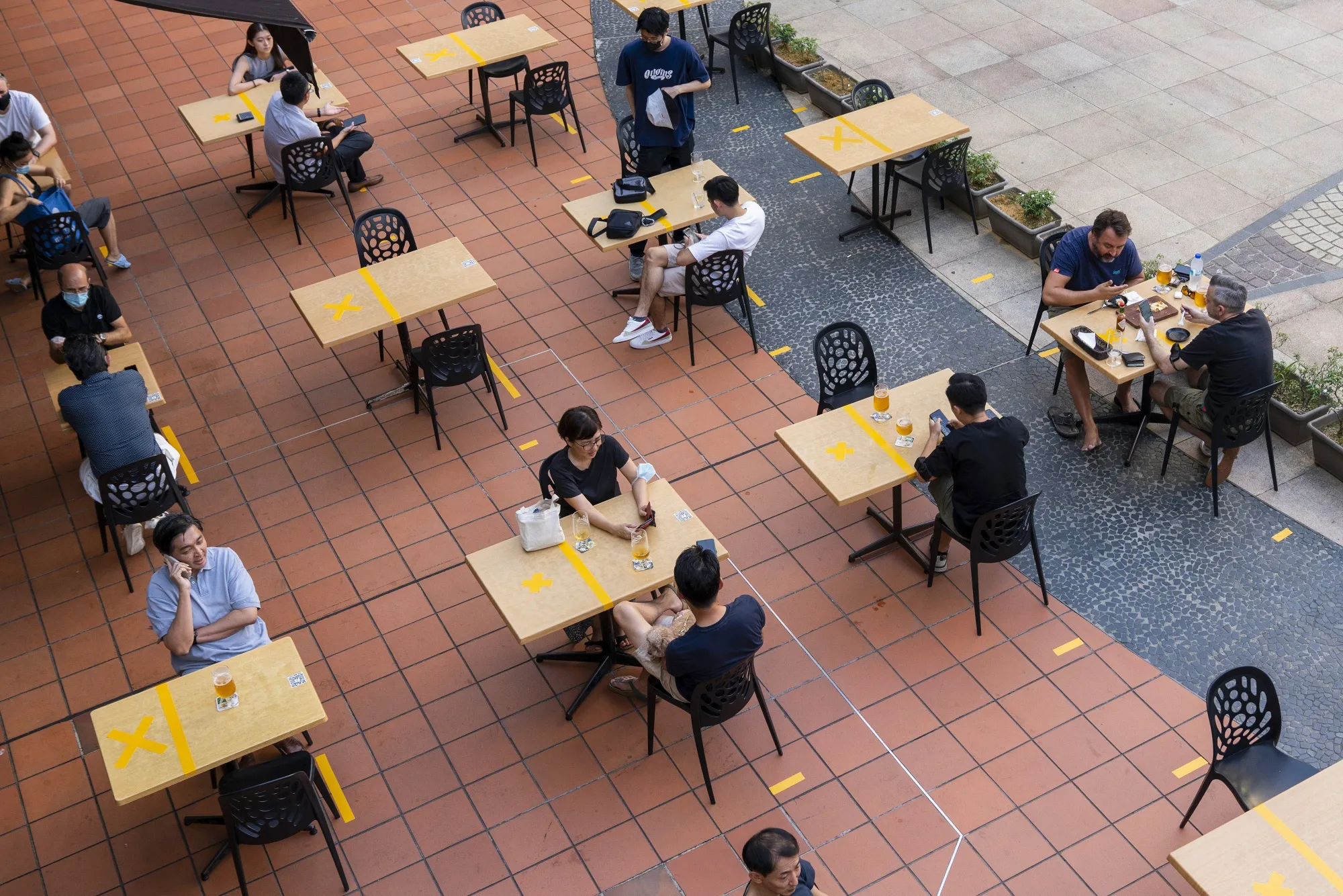 Customers sit at socially distanced tables outside a restaurant in Singapore in June.
