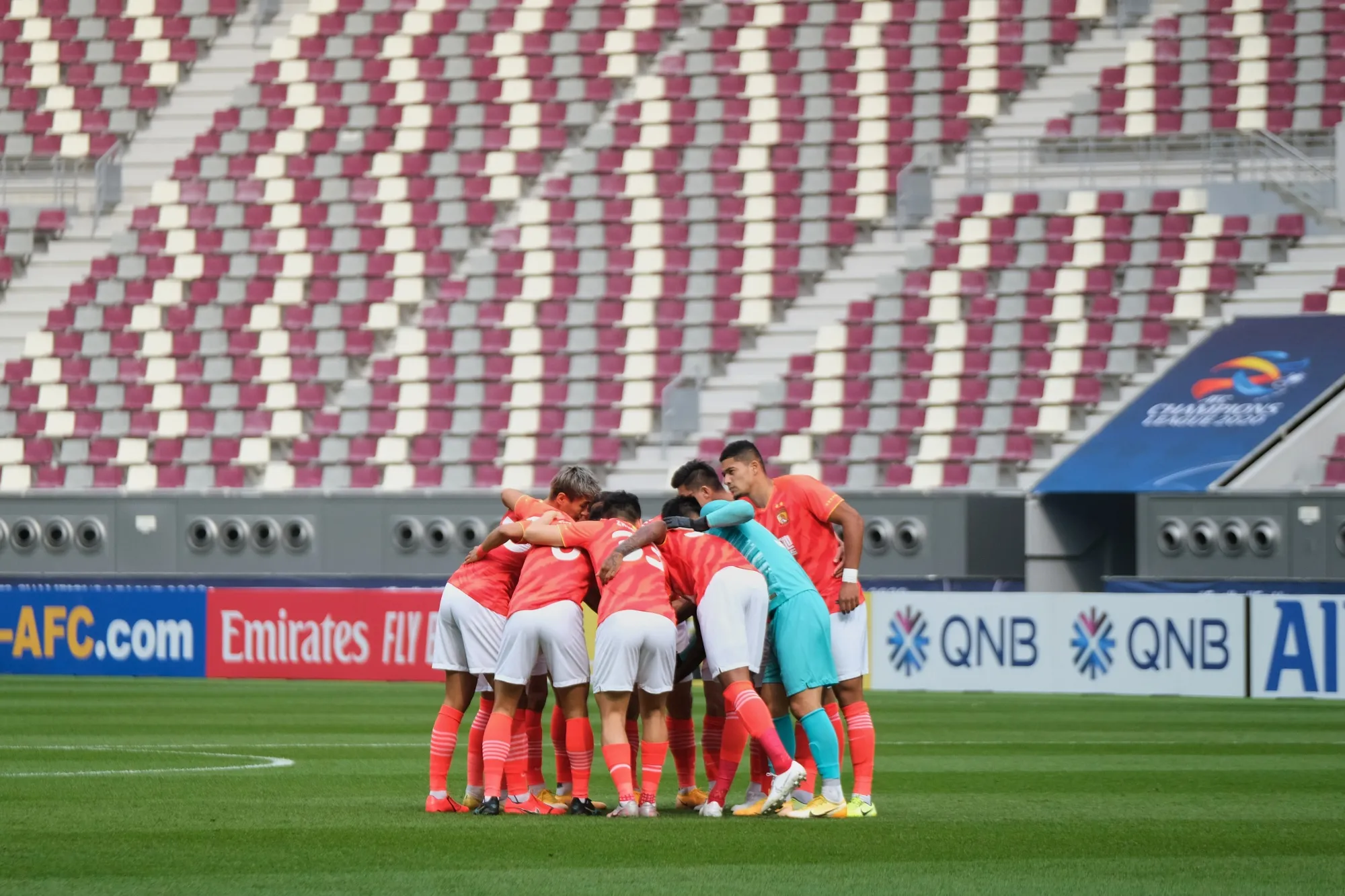 Guangzhou Evergrande huddle before a game in Doha in 2020.&nbsp;