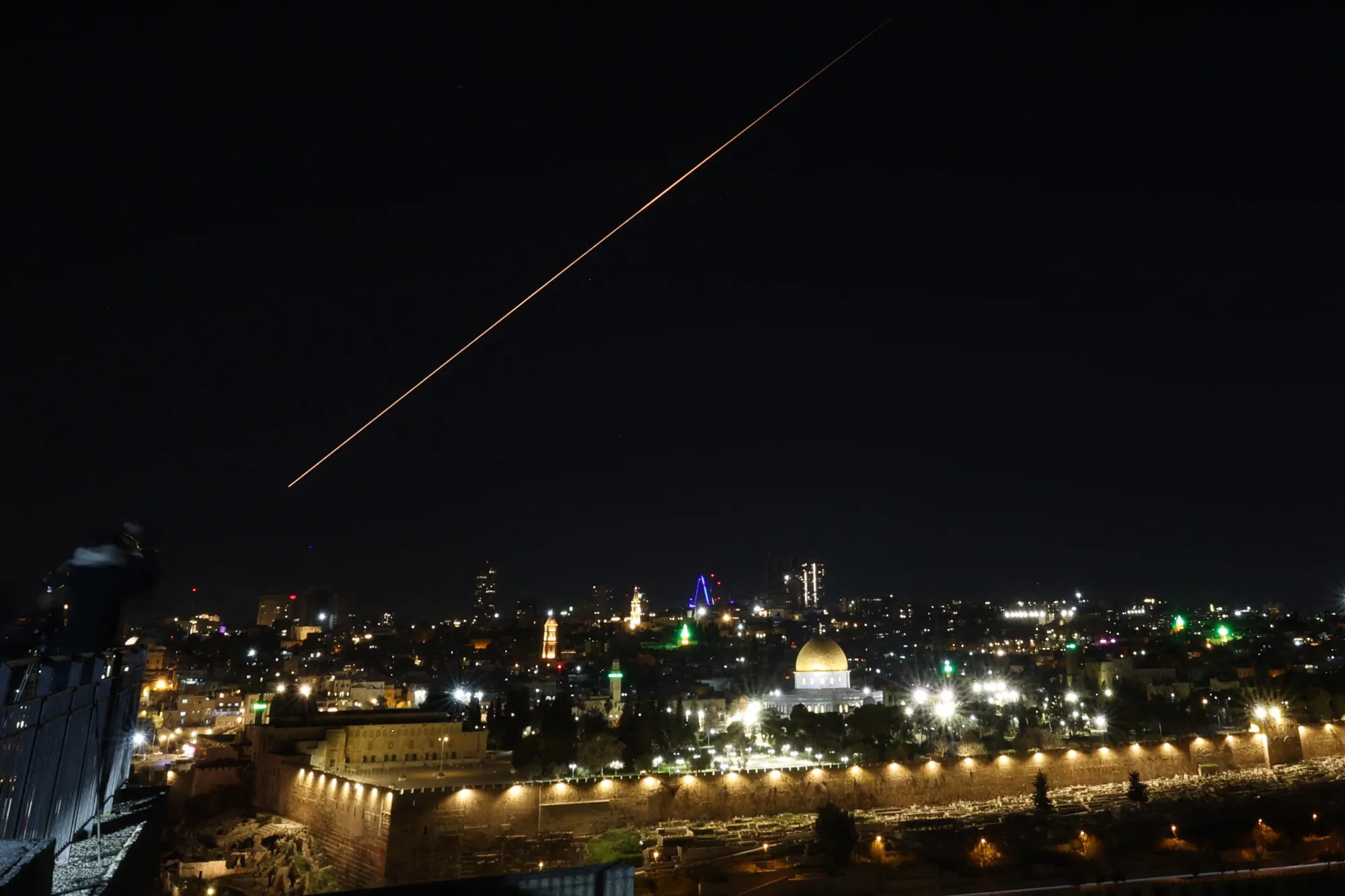 A military projectile is seen in the sky over the Dome of the Rock and the Al-Aqsa Mosque in Jerusalem on Feb. 28.