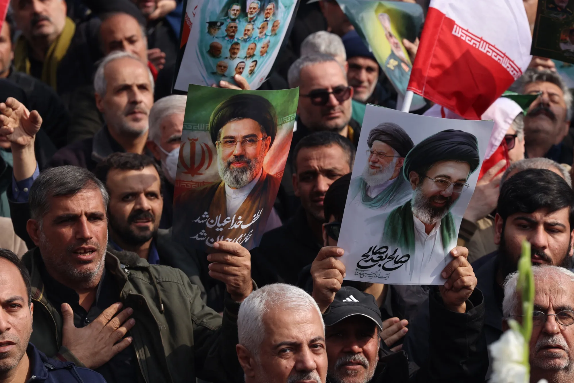 Iranians hold posters bearing the portrait of Mojtaba Khamenei in Enghelab Square, Tehran, on March 11.