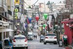 Pedestrians wearing protective face masks walk through an empty street in the Itaewon district of Seoul, South Korea, on Friday, Aug. 21, 2020.