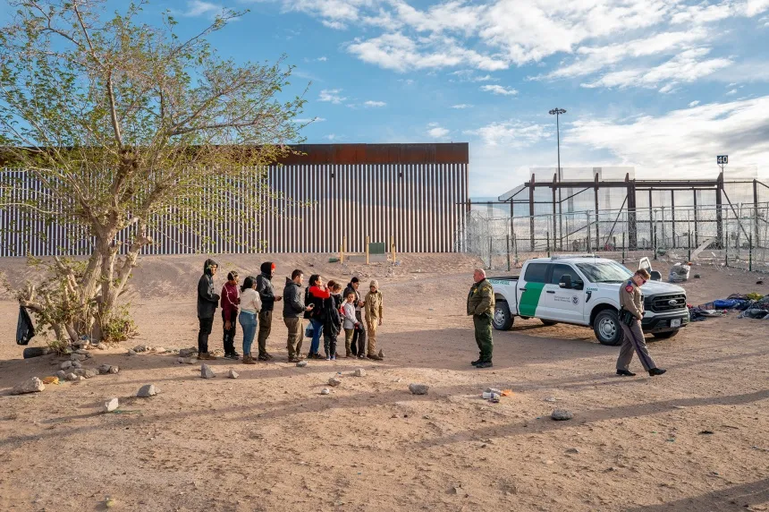 A group of migrants wait to be processed after crossing the Rio Grande river&nbsp;in El Paso, Texas, on April 2.&nbsp;
