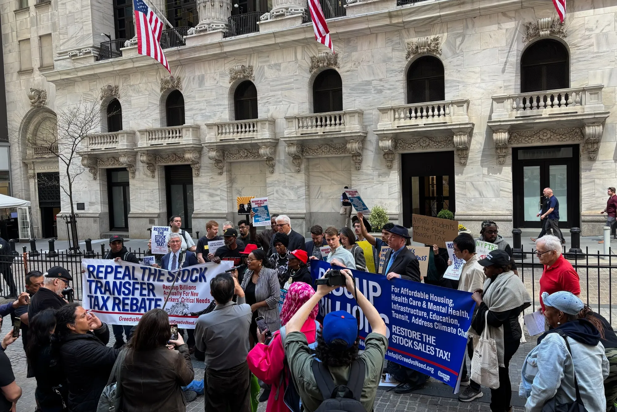 Supporters of a proposal to tax stock sale transactions outside the New York Stock Exchange on April 23.