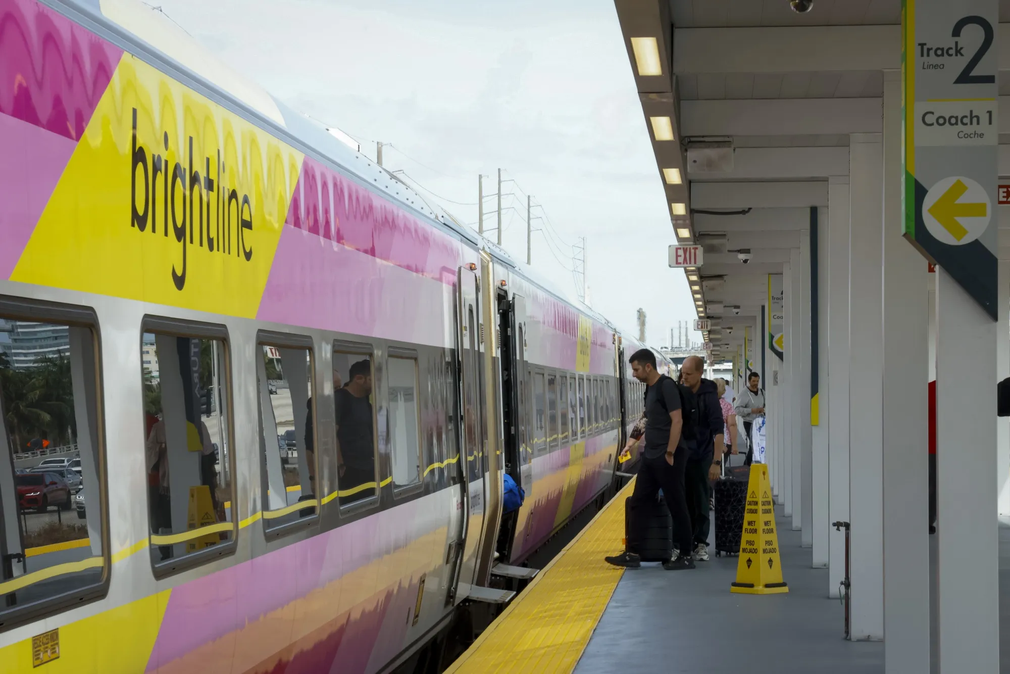 Passengers board a Brightline train in Aventura, Florida.