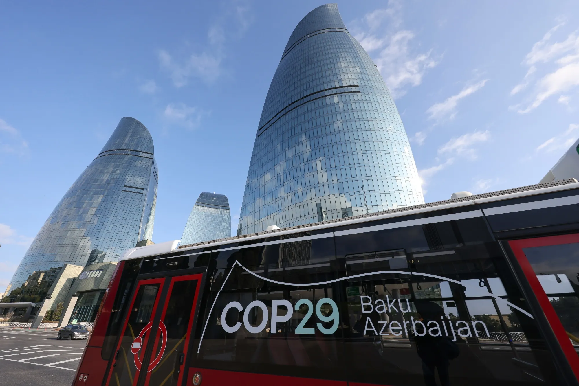 A city bus near the Flame Towers during the COP29 climate change conference in Baku, Azerbaijan.
