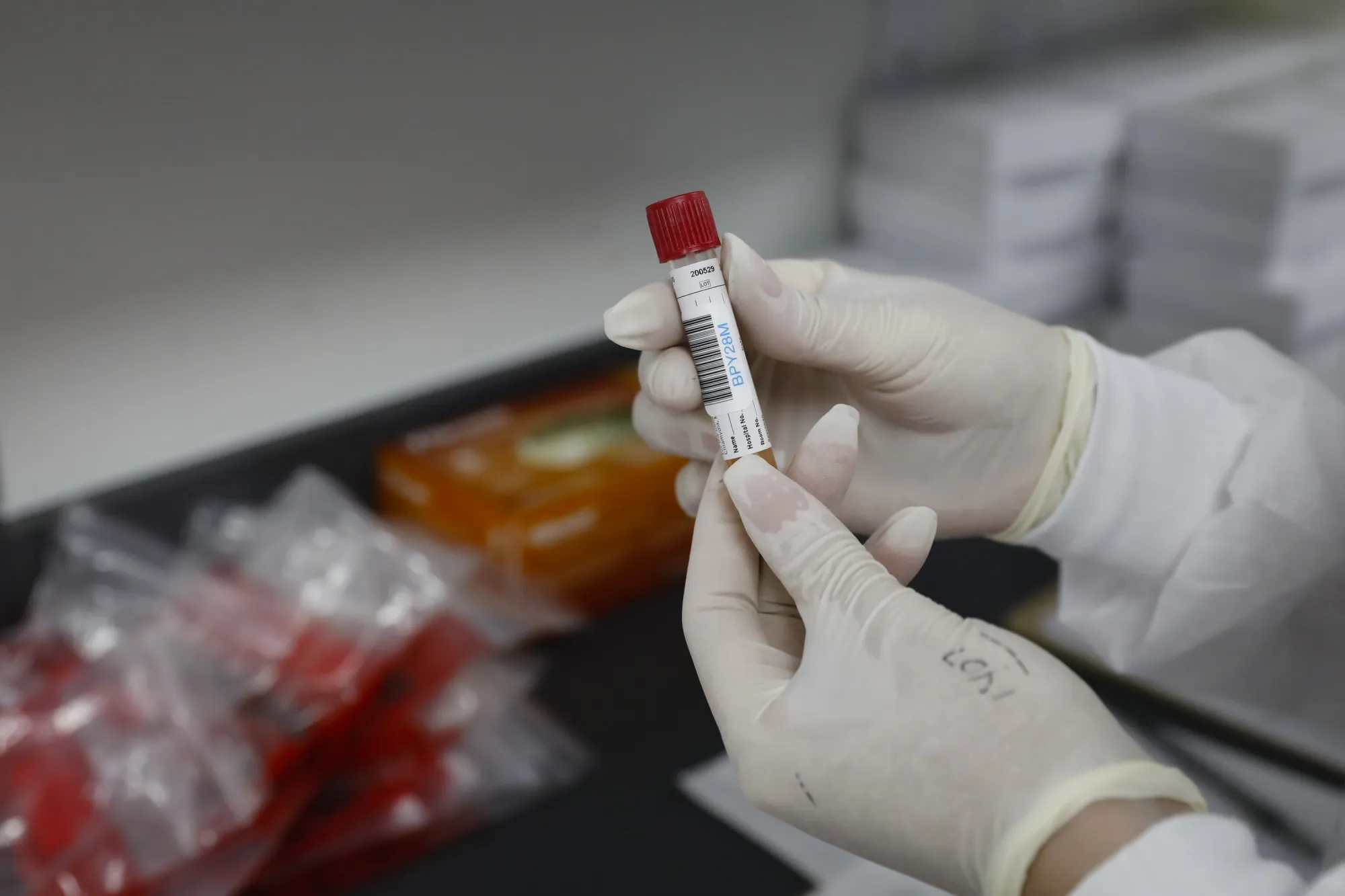 A health worker holds blood samples during clinical trials for a Covid-19 vaccine at Research Centers of America in Hollywood, Florida, U.S., on Wednesday, Sept. 9, 2020. Drugmakers racing to produce Covid-19 vaccines pledged to avoid shortcuts on science as they face pressure to rush a shot to market.