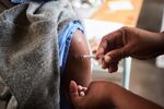 A health worker administers a vaccine.