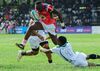 Kenya's Isaac Adimo, center, vies with Zimbabwe's Lenience Tambwera during a match that acts a qualifier for the 2019 Rugby World Cup in Japan.