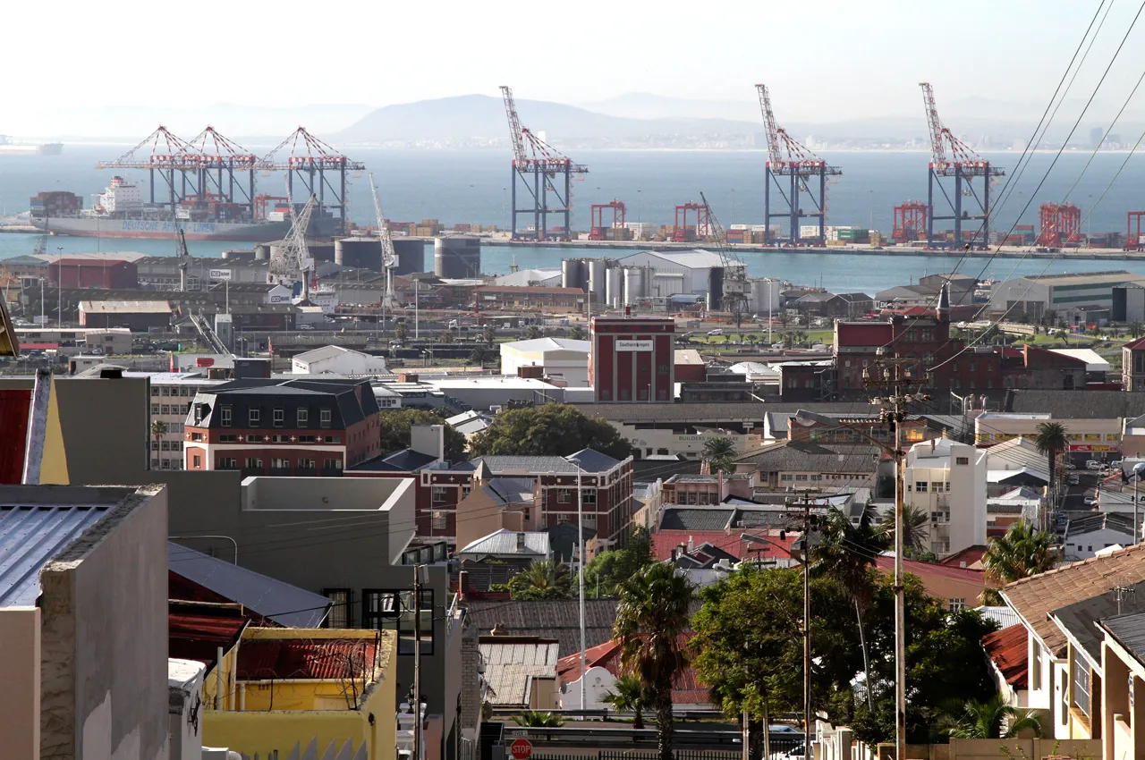 The residential district of Woodstock overlooks cranes on the harbourside in the commercial port area of Cape Town, South Africa. Photograph by0xA0Nadine Hutton/Bloomberg