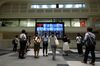 Visitors look at screens displaying stock indices at the Tokyo Stock Exchange (TSE), operated by Japan Exchange Group Inc. (JPX), in Tokyo, Japan, on Tuesday, July 24, 2018.