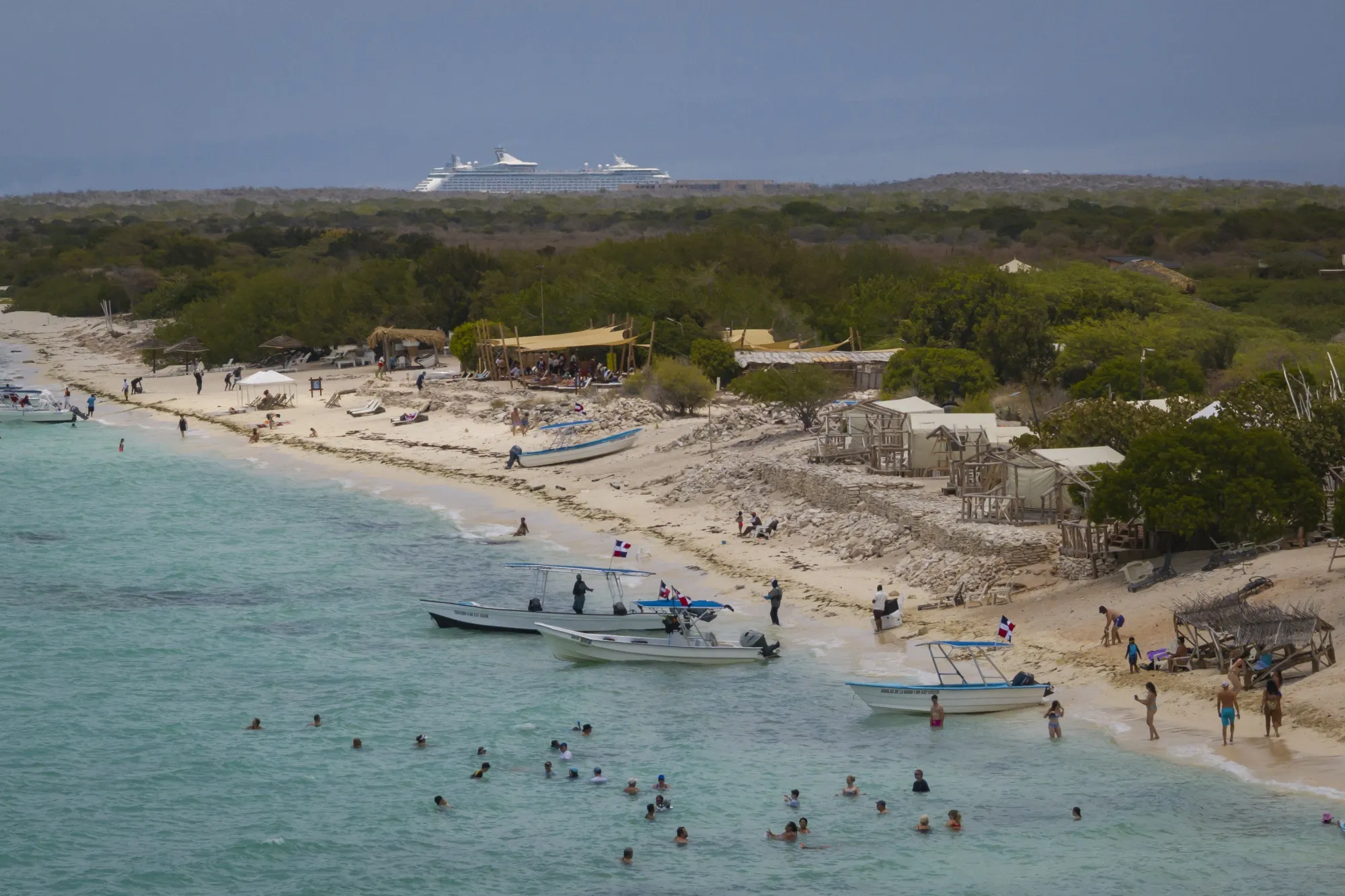 Tourists at Bahia de las Aguilas beach in Cabo Rojo, Dominican Republic.