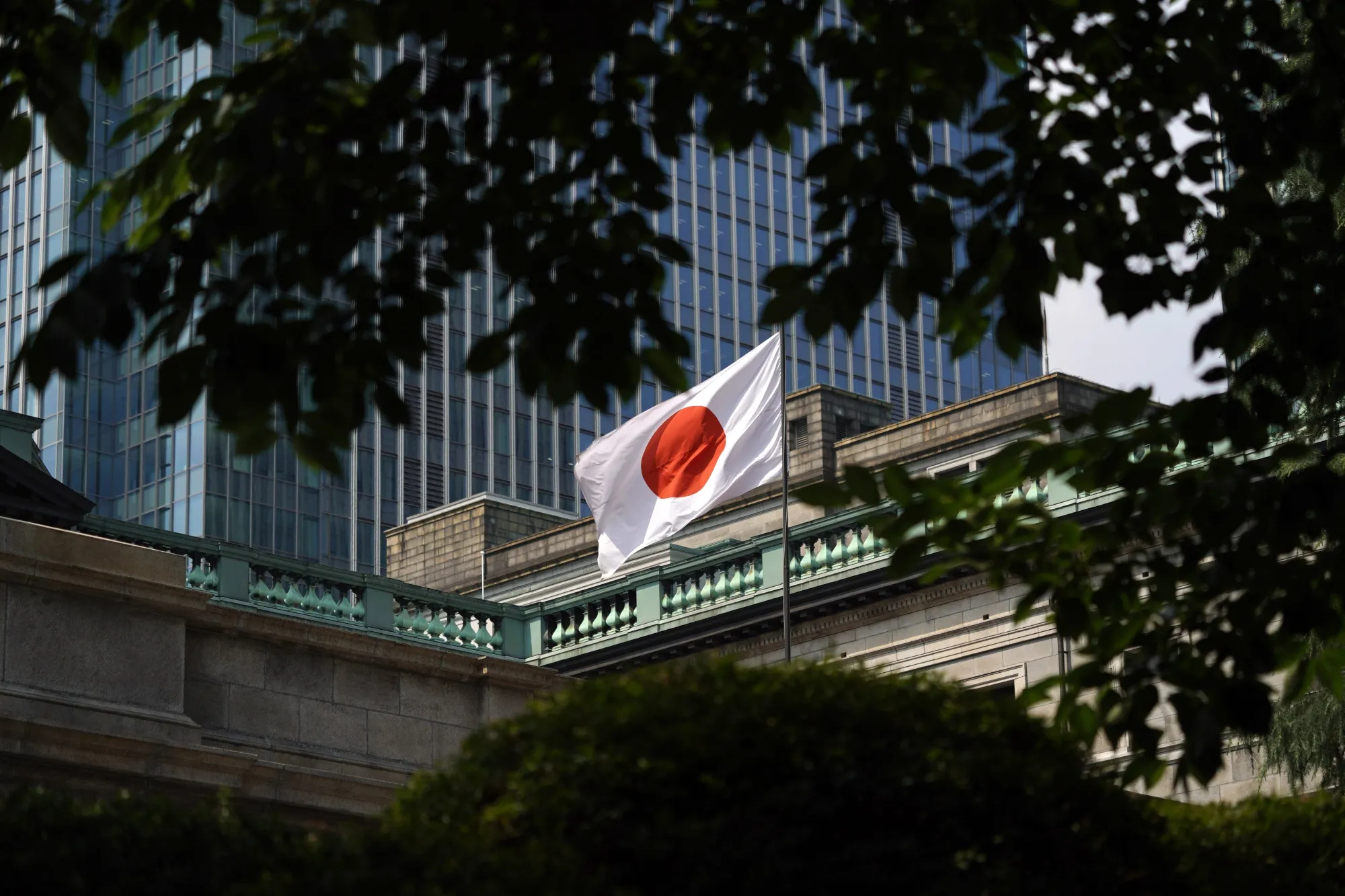 A Japanese national flag flies outside the Bank of Japan headquarters in Tokyo.