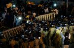 Anti-riot police officers attempt to block protesters during a protest in Colombo, on April 7.