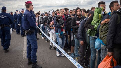 Migrants who have just crossed into Hungary wait for buses to take them to an intake camp on Monday.