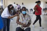 A health-care worker administers a Covid-19 vaccination in Santo Domingo,&nbsp;Dominican Republic.