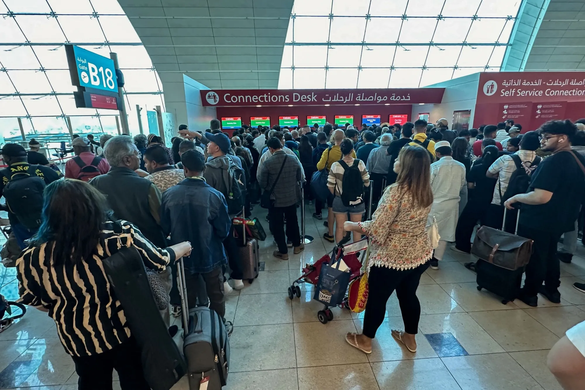 Passengers queue at a flight connection desk at Dubai International Airport on April 17.