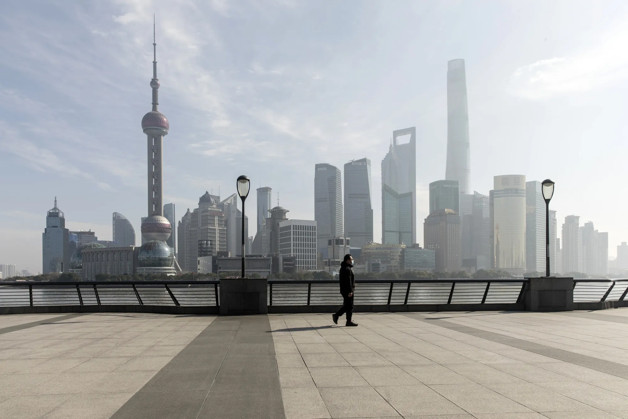 A pedestrian walks along the waterfront in Shanghai on Monday.