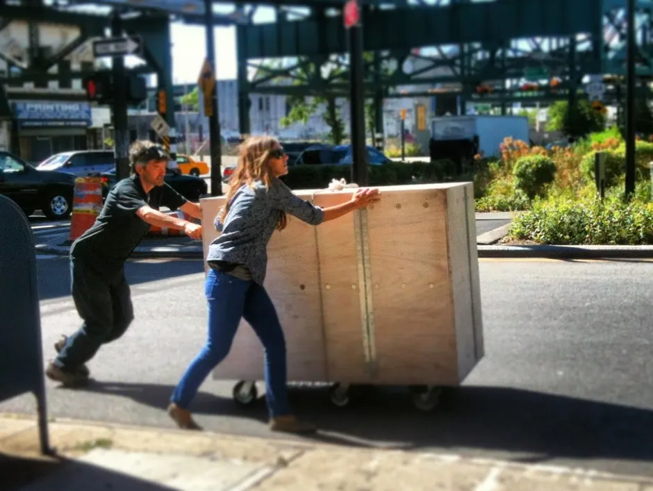 Sam Davol and his wife, Leslie, acting as roadies to set up a portable reading room for the Uni Project in Queens.