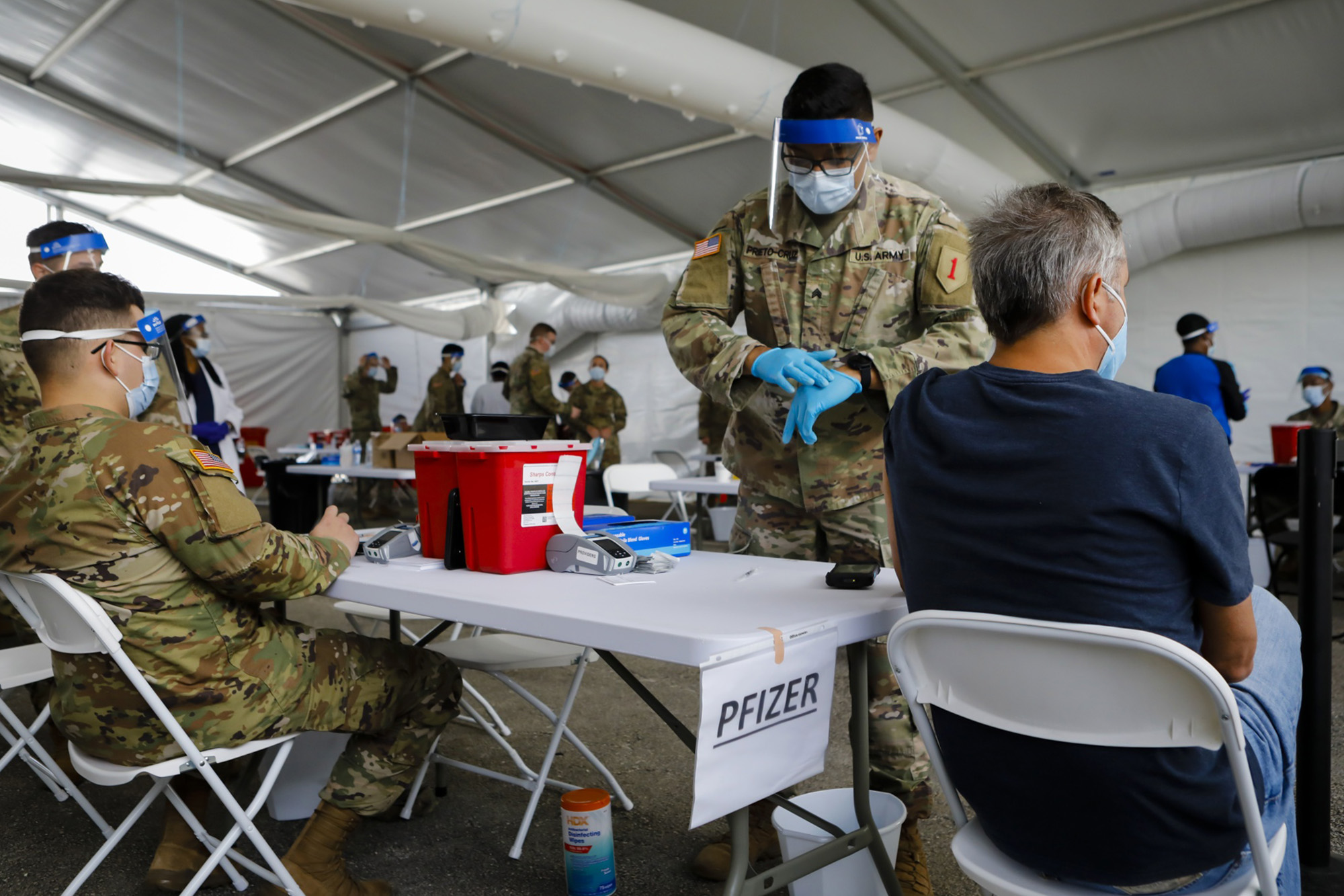 A U.S. Army soldier prepares to administer a dose of Covid-19 vaccine at a vaccination center in North Miami, Florida.