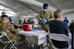 A U.S. Army soldier prepares to administer a Covid-19 vaccine dose at a vaccination center&nbsp;in North Miami, Florida.