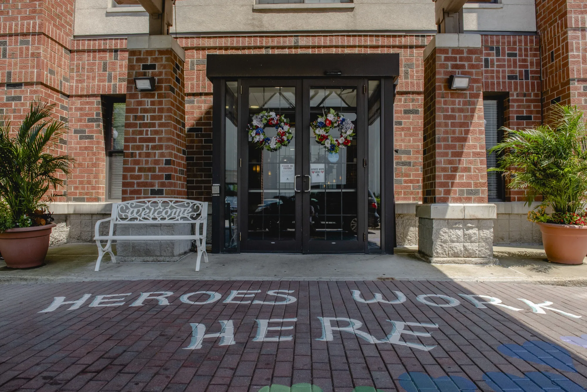 A mural that reads "Heroes Work&nbsp;Here" is painted outside the Maple Pointe Assisted Living - A Chelsea Community facility in Rockville Centre, New York,&nbsp;on June 9.