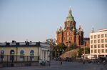 Pedestrians pass in front of the Uspenskin cathedral in Helsinki, Finland.