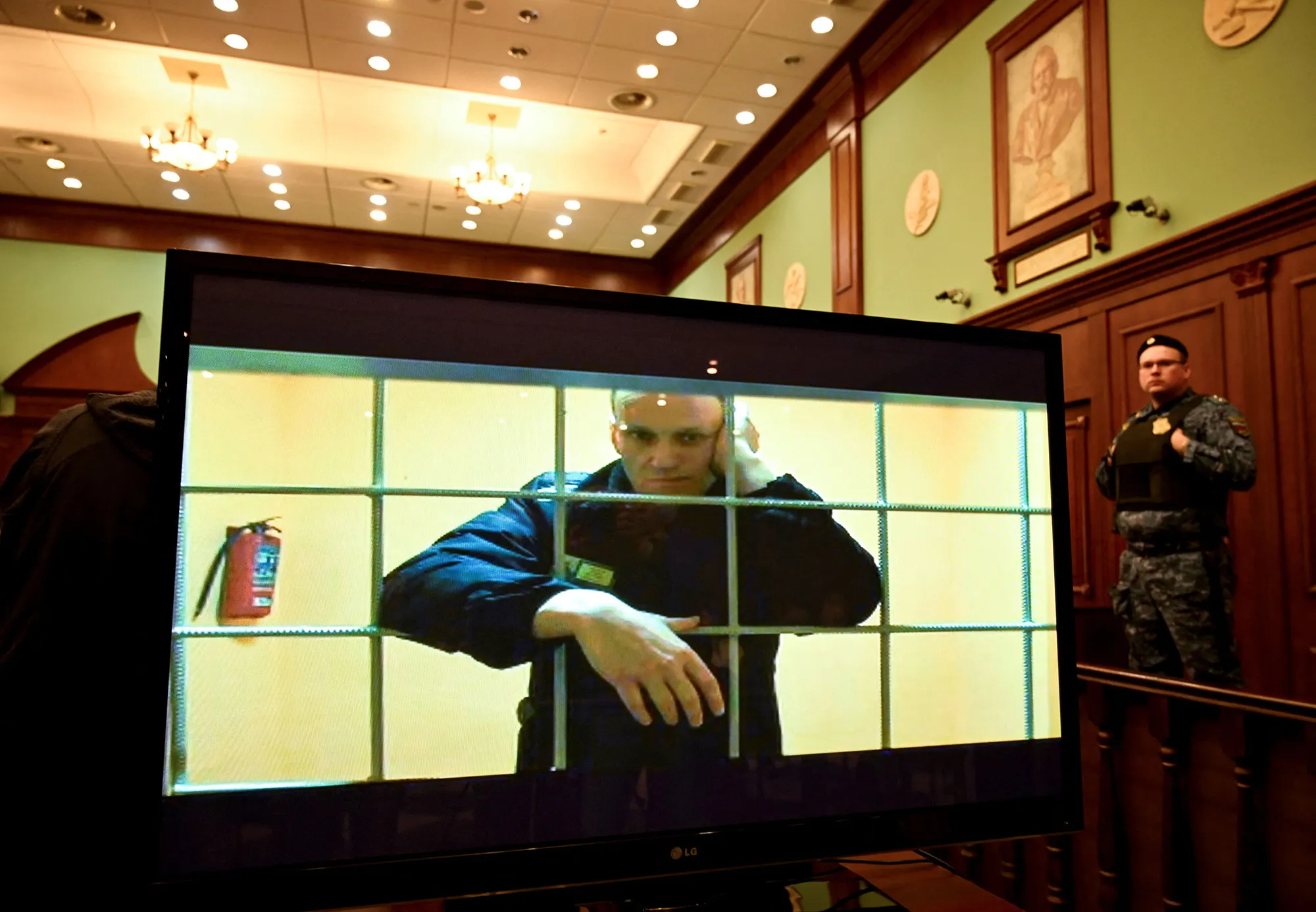 Alexei Navalny appears on a screen set up in a courtroom of the Moscow City Court via a video link from his prison colony during a hearing, in Moscow on May 24.