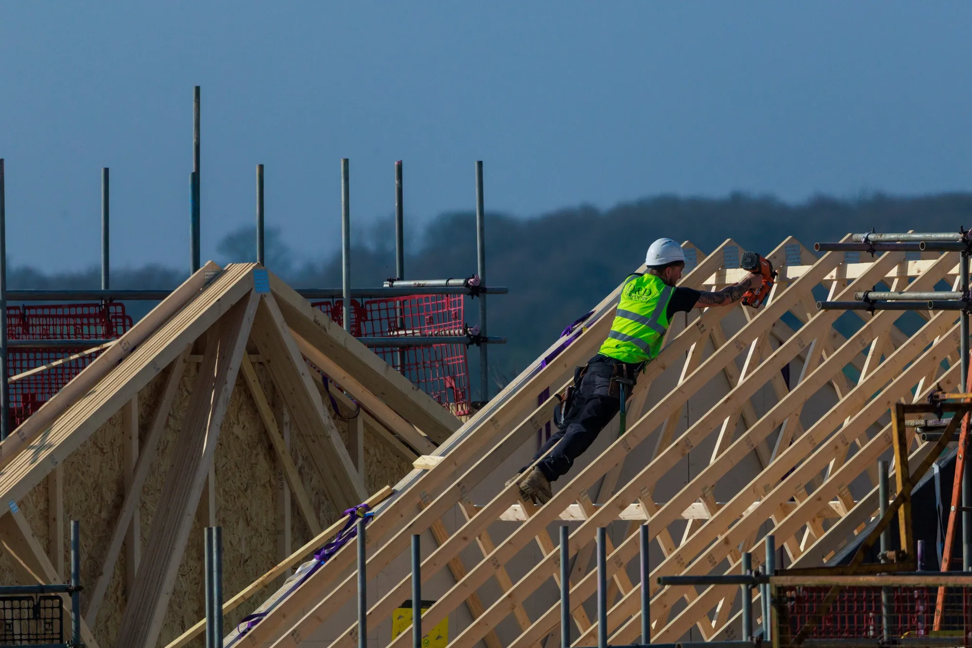 A construction worker works on a roof at a Persimmon Plc's housing site near Sheerness.