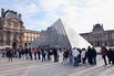 Visitors queue to enter the Louvre museum in October.