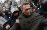 Police officers detain protest leader Alexei Navalny outside Zamoskvoretsky district court in Moscow, on February 24, 2014, during a protest against the trial of eight people accused of instigating mass riots after an opposition rally on Moscow's on Bolotnaya square turned violent on the eve of Vladimir Putin's inauguration as president in 2012.
