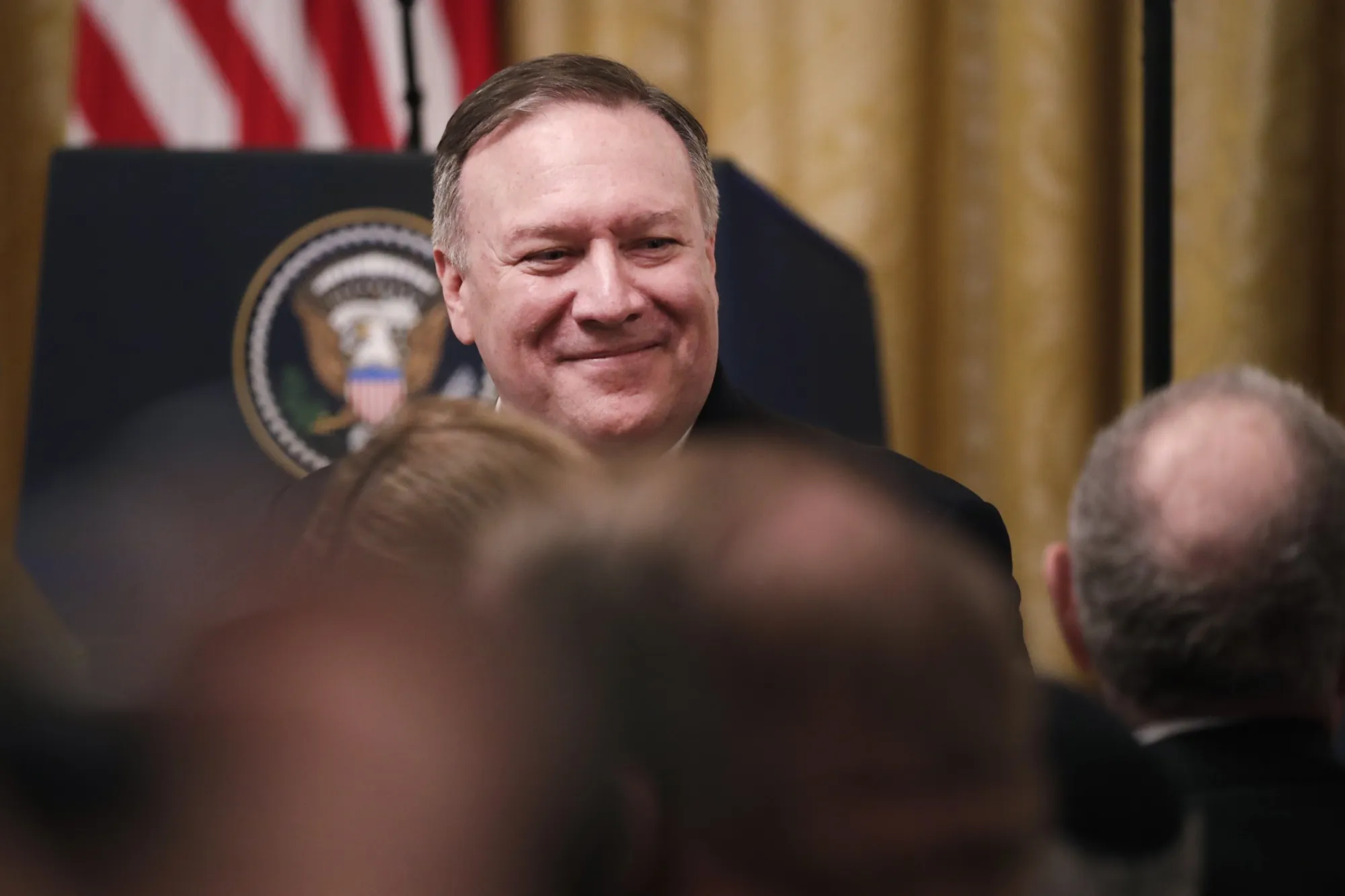 Mike Pompeo, U.S. secretary of state, speaks with attendees while arriving for a news conference in the East Room of the White House in Washington on Jan. 28, 2020.&nbsp;