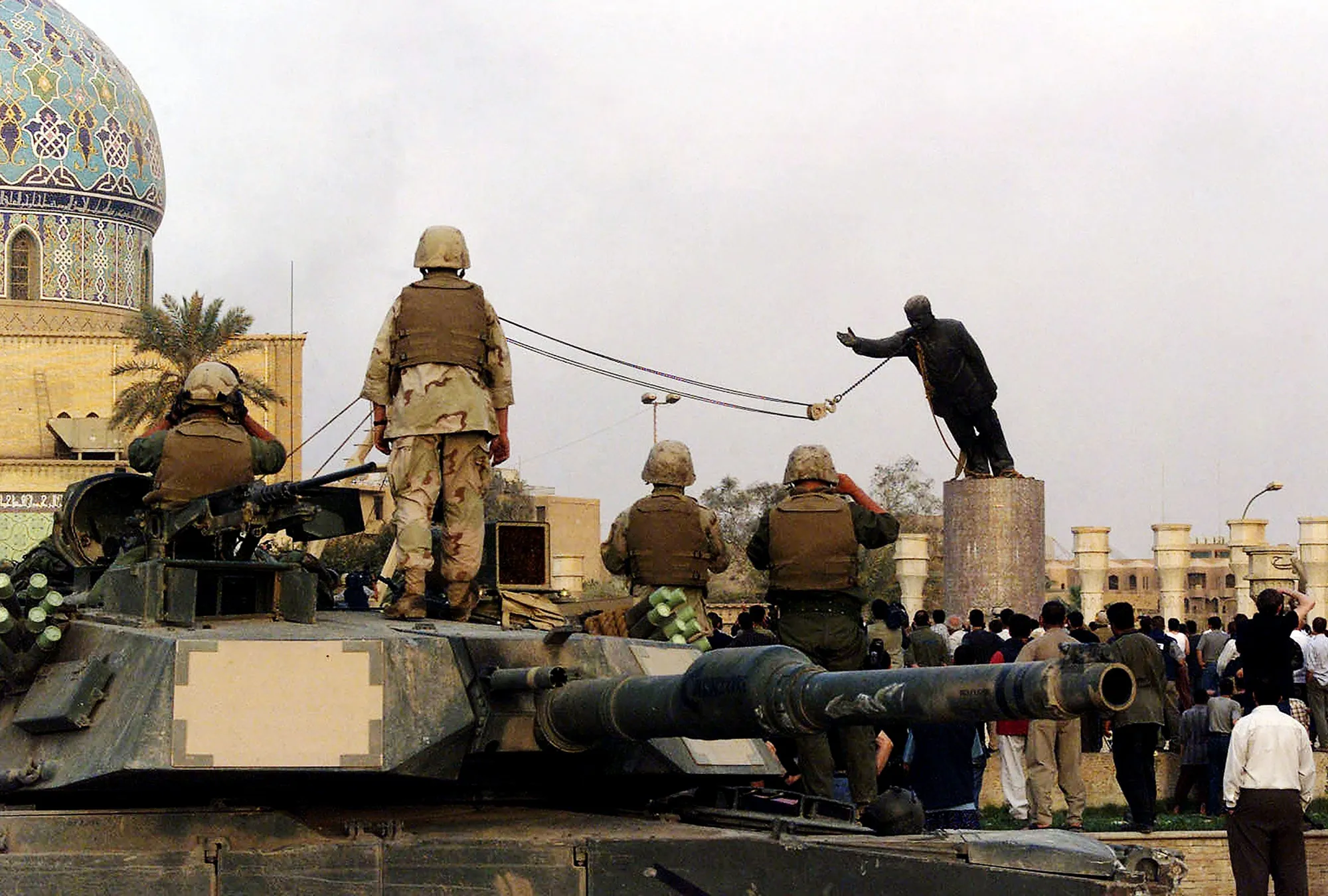 &nbsp;U.S. Marines and Iraqis watch&nbsp;as the statue of&nbsp;Saddam Hussein is toppled at al-Fardous square in Baghdad, in 2003.&nbsp;