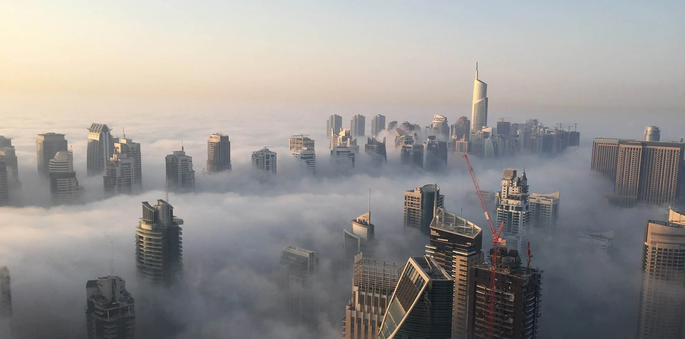 A general view shows the part of the skyline of Dubai covered in an early morning fog on October 5, 2015. AFP PHOTO / RENE SLAMA (Photo credit should read RENE SLAMA/AFP/Getty Images)

