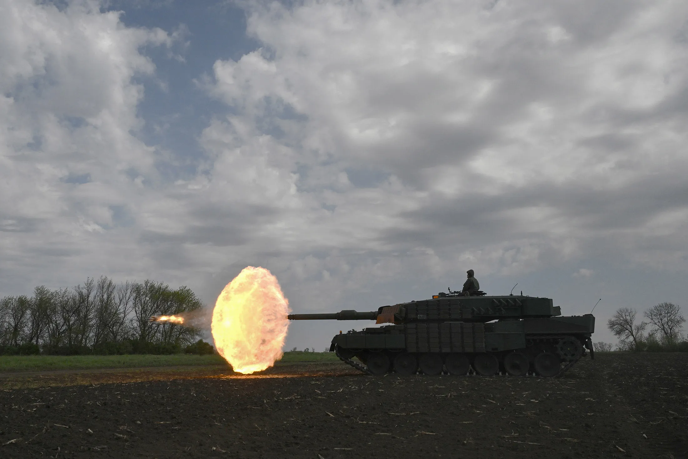 &nbsp;A Ukrainian tank crew of the 33rd Separate Mechanized Brigade fire a round from a Leopard 2A4 tank during a field training exercise at an undisclosed location in Ukraine, on April 30.