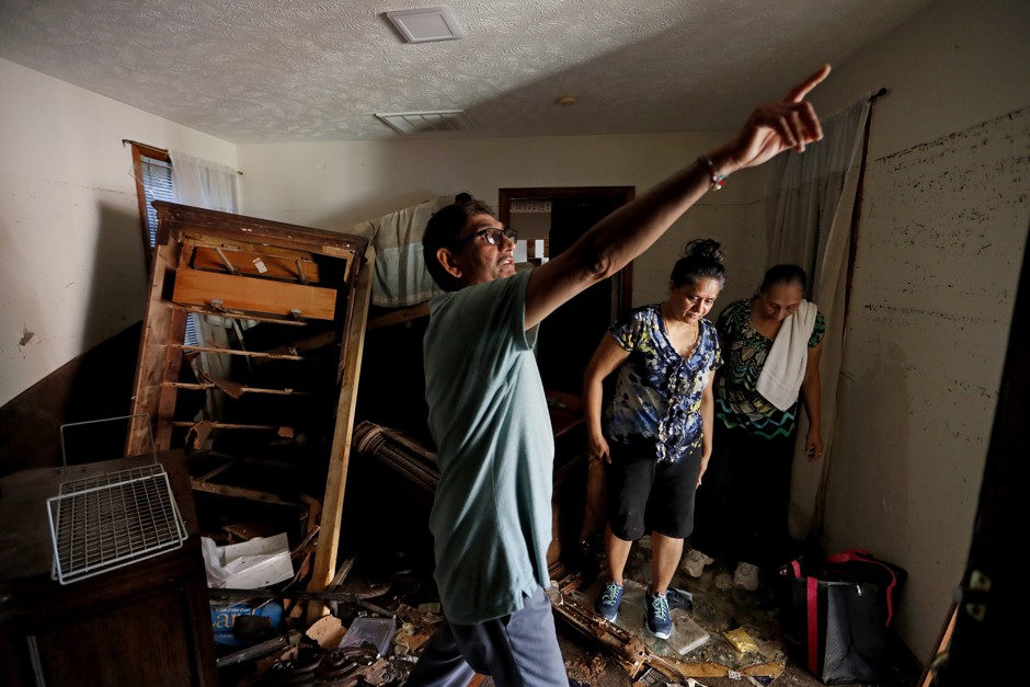 Smita Depani, center, surveys flood damage to her apartment with her relatives in Spring Lake, North Carolina, after Hurricane Florence in September.