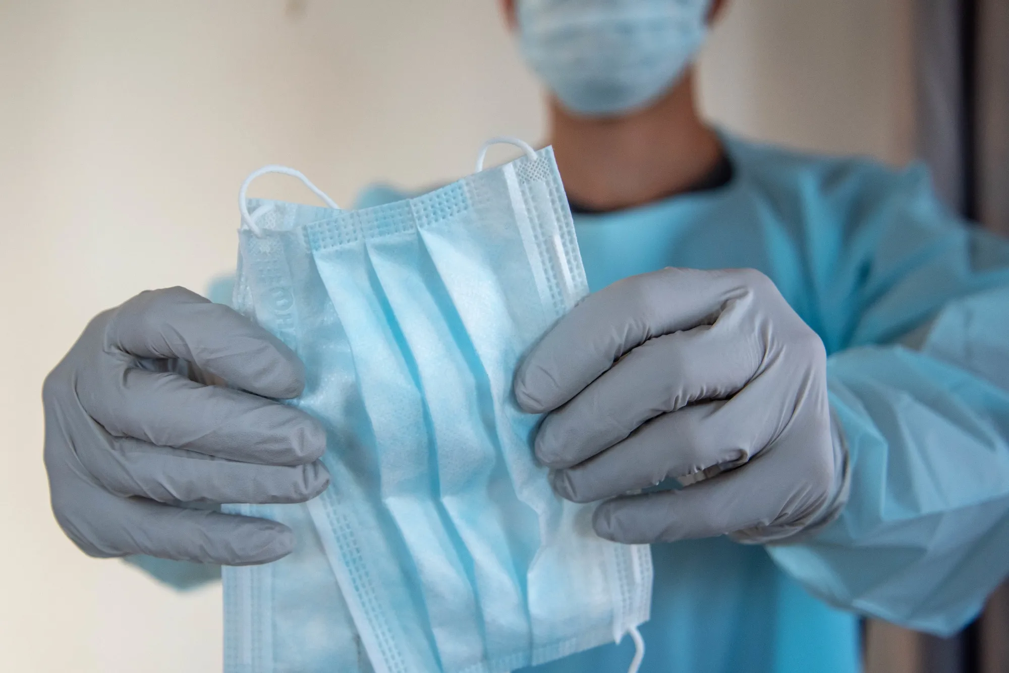 In this photo illustration a health care worker holds a face