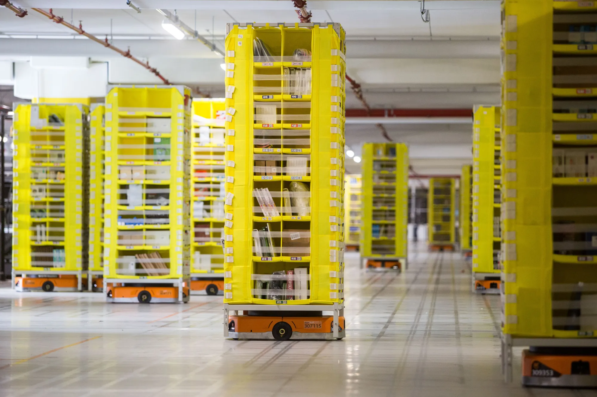 Automated transport robots move goods in storage units at an&nbsp;Amazon&nbsp;fulfillment center in Passo Corese, Italy.
