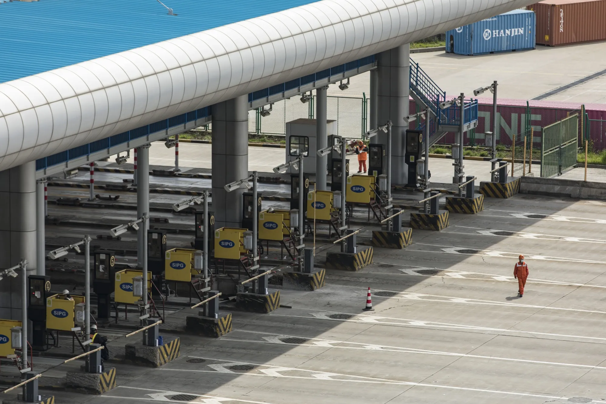 A worker walks across empty lanes at the truck entrance to the Yangshan Deepwater Port in Shanghai, China, on&nbsp;March 23.&nbsp;