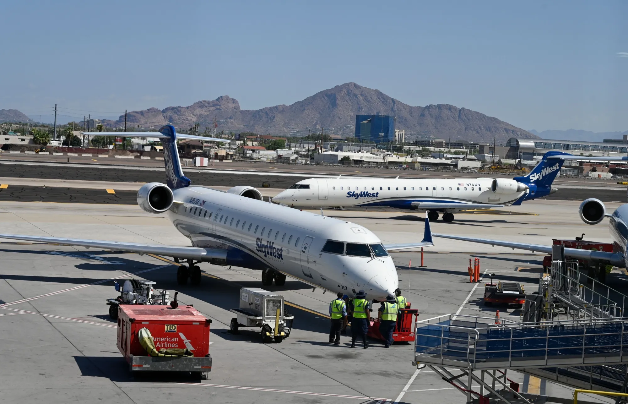 Ground crew workers service an Skywest plane at Phoenix Sky Harbor International Airport.