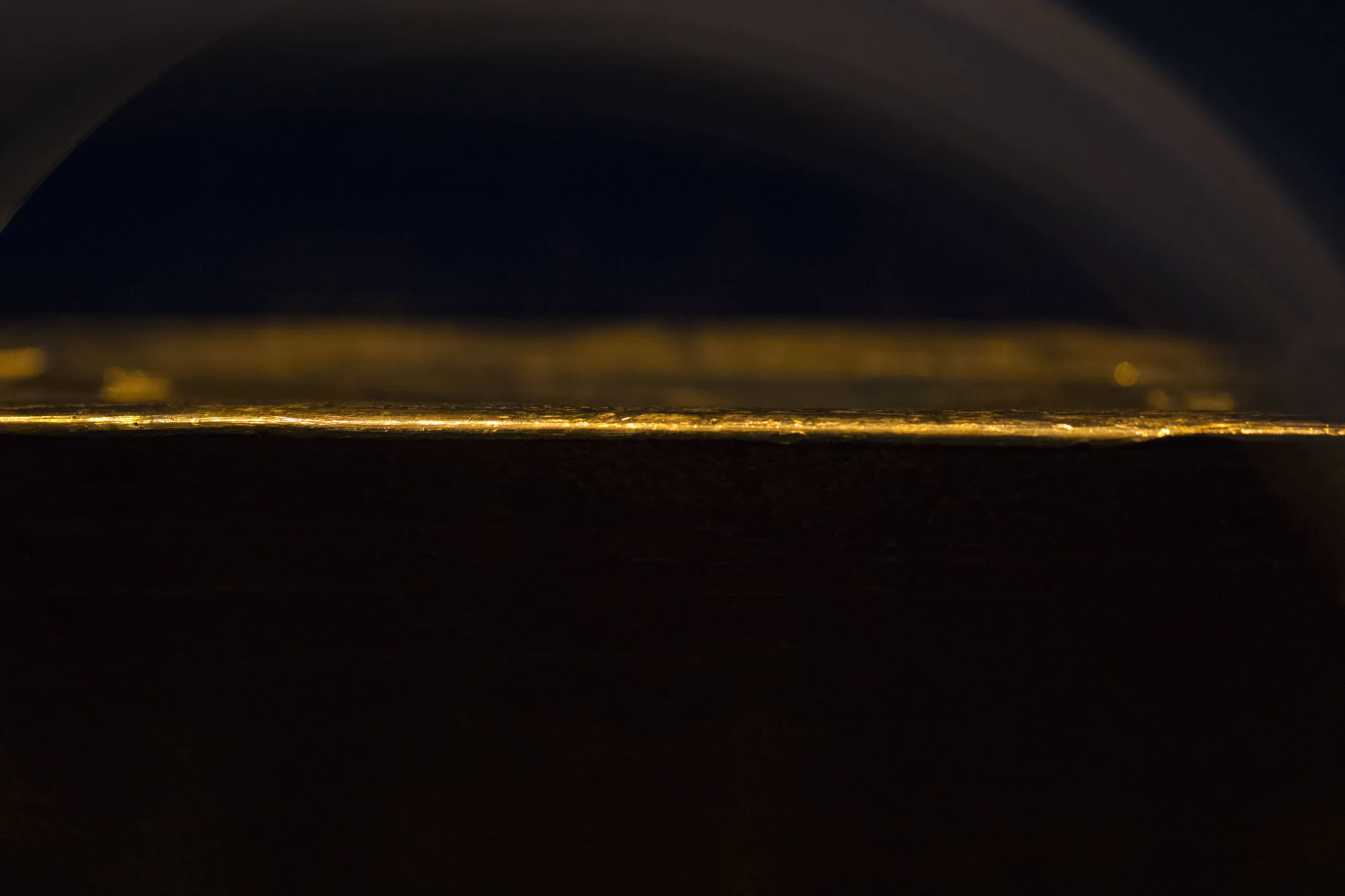 Light illuminates the edge of a gold ingot on display inside the Deutsche Bundesbank's money museum in Frankfurt, Germany