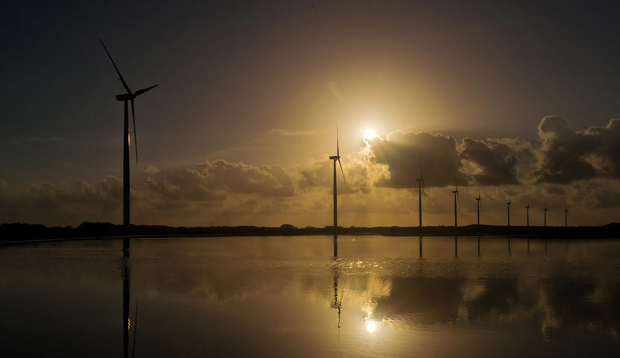 Wind turbines stand during sunset at the Avangrid Renewables' Baffin Wind Power Project in Sarita, Texas.