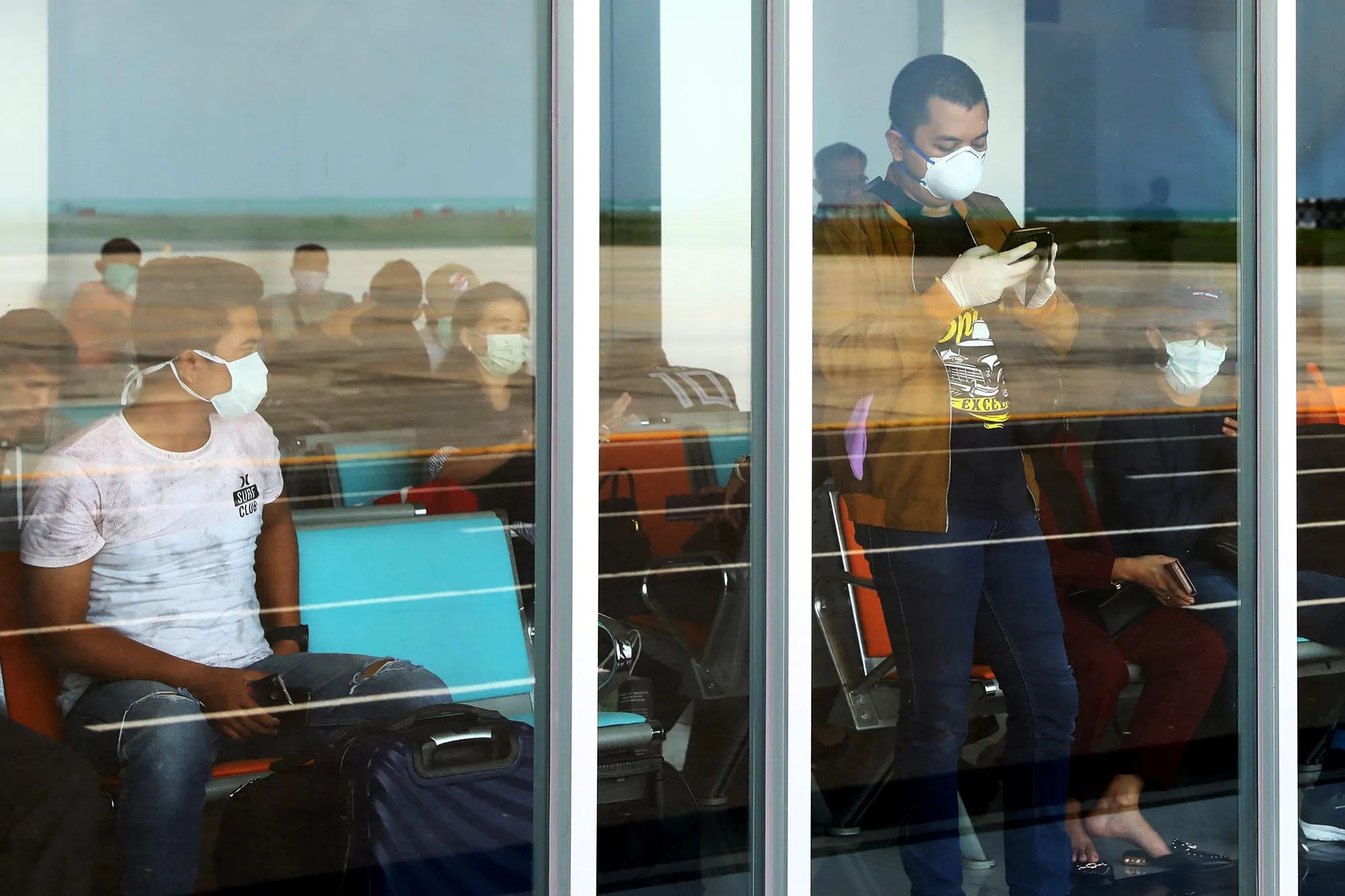 People wait&nbsp;at the Raden Sadjad airport in Ranai, Natuna island, Indonesia, on Feb 3.