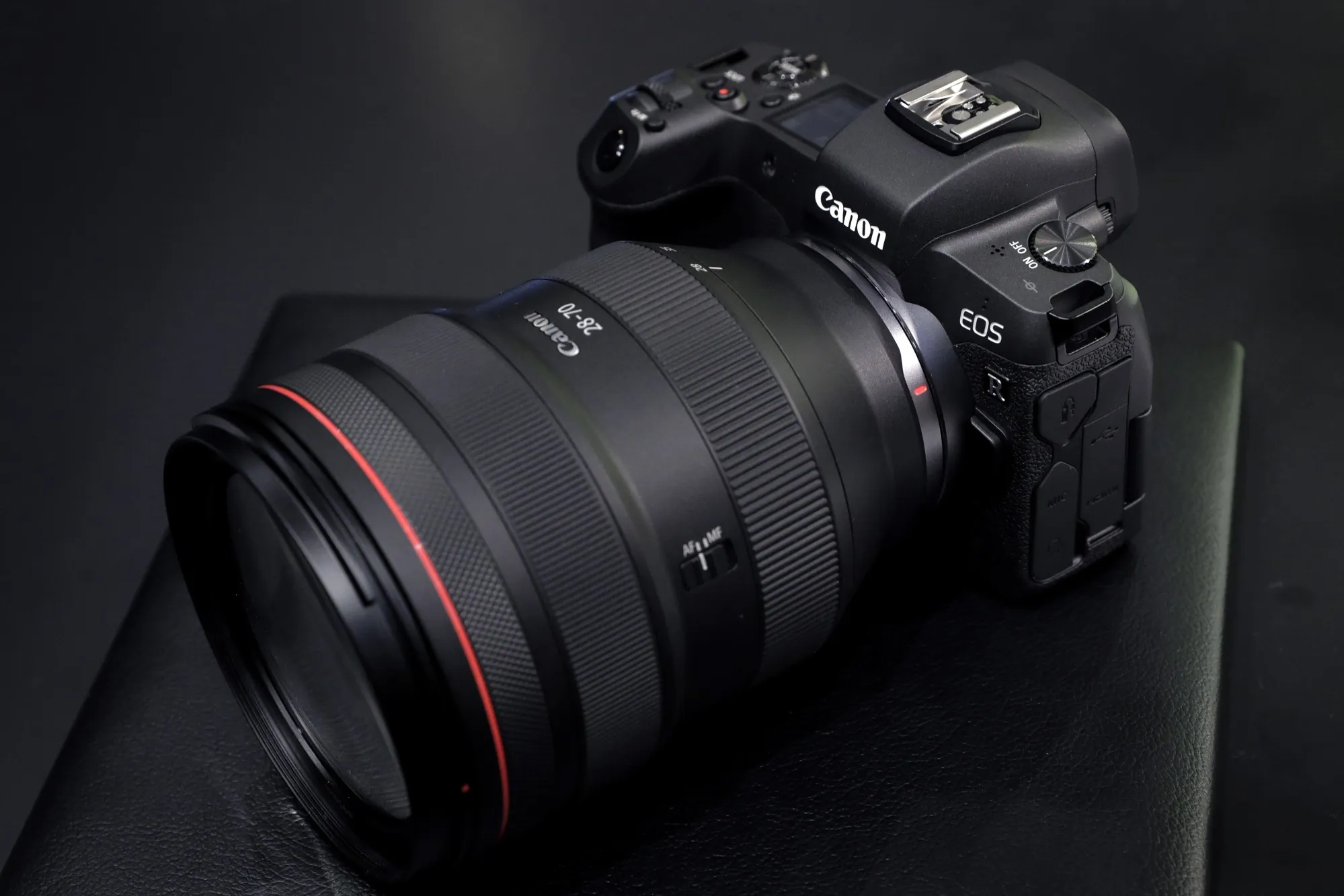 A Canon Inc. EOS R mirrorless digital camera mounted with an RF 28-70mm f/2L USM standard zoom lens is displayed at an unveiling event in Tokyo.