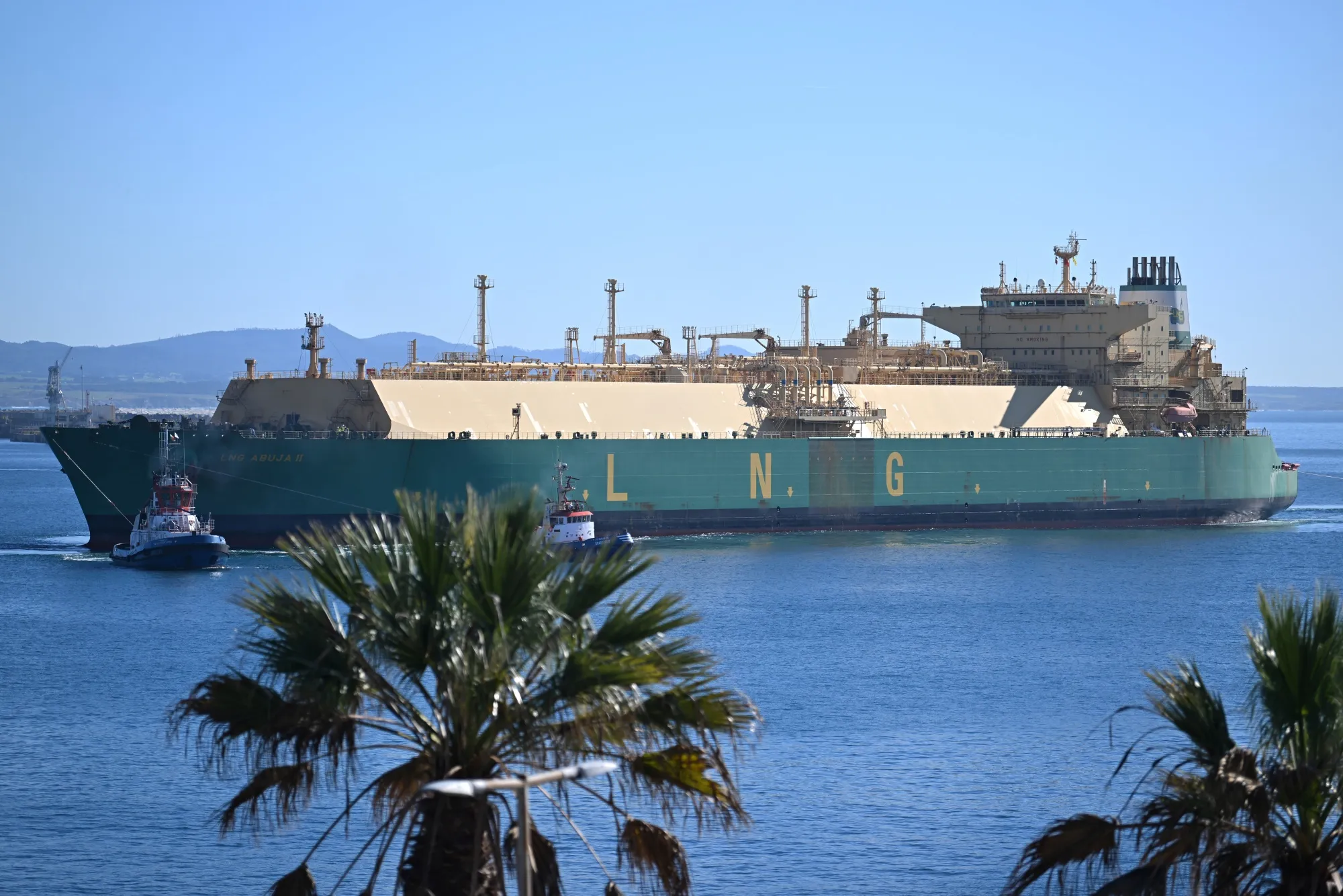 A tug boat pulls a liquefied natural gas carrier into the port of Sines, Portugal.