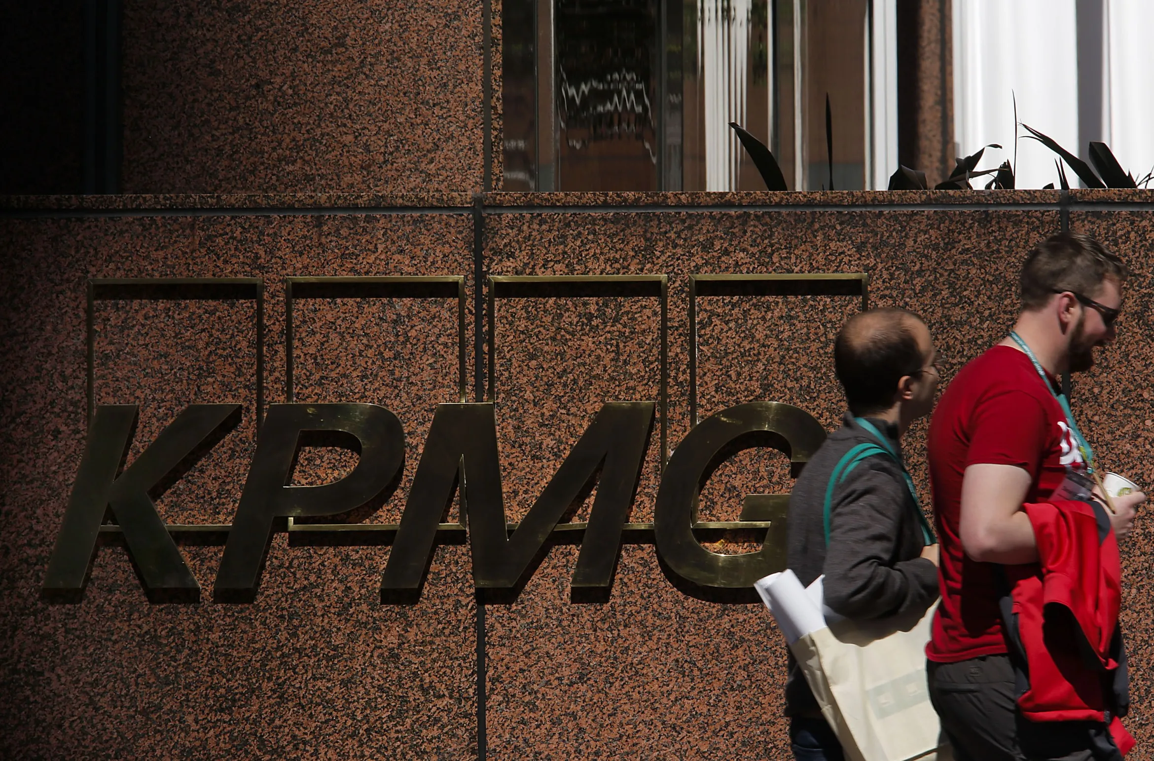 Pedestrians walk past the KPMG offices&nbsp;in Los Angeles.