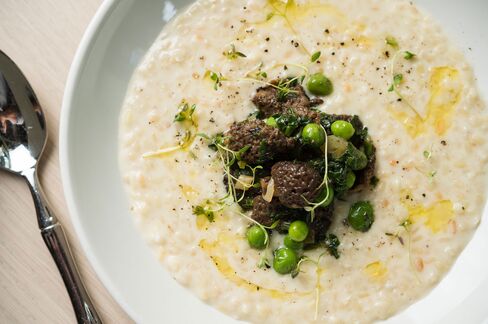 White lentils served like risotto, instead of dal, and crowned with mushrooms and peas.