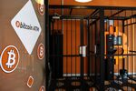 A security cage protects the automated teller machine (ATM) of a cryptocurrency kiosk.