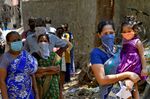 People stand in line to get tested for the the coronavirus inside Dharavi, in Mumbai on April 16.
