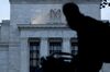 A pedestrian walks past the Marriner S. Eccles Federal Reserve building in Washington, D.C., U.S., on Monday, Aug. 13, 2018. Federal Reserve officials left U.S. interest rates unchanged in August and stuck with a plan to gradually lift borrowing costs amid strong growth that backs bets for a hike in September.