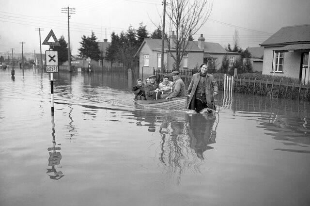 Flood victims in Canvey Island, Essex, are towed to safety in 1953.